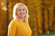 © New Africa - Portrait of happy mature woman in park on sunny day