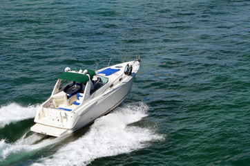 Wall Mural - White high-end cabin cruiser speeding across the Florida Intra-Coastal Waterway off Miami Beach