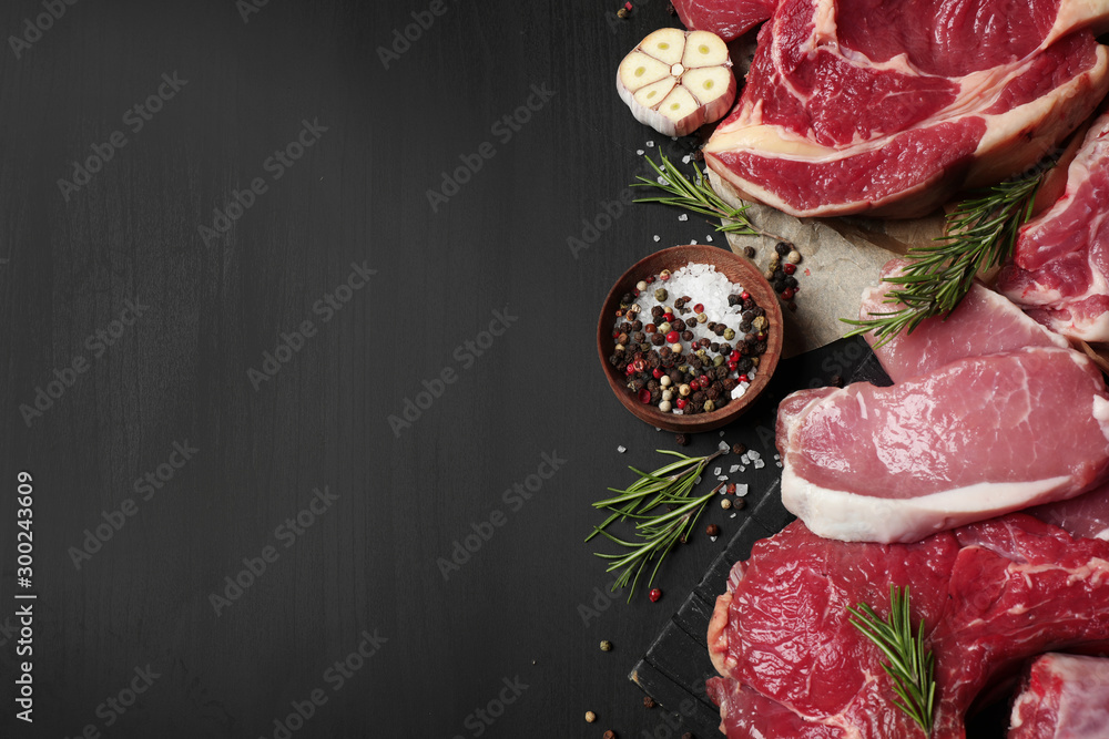 Flat lay composition with fresh meat on dark table. Space for text - obrazy, fototapety, plakaty 