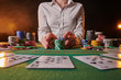 © Anton - croupier accepts bets at casino, poker table, chips, dollars