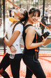 © Strelciuc - Portrait of two young women laughing after doing morning exercises. Weight loss concept.
