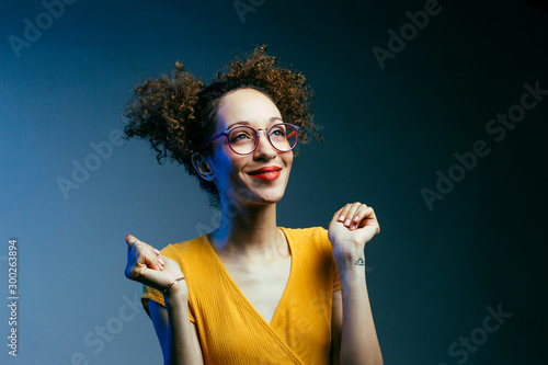 Cuadros en Lienzo Portrait of a smiling young woman wishing for something, hoping for thew best an