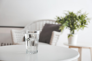 Canvas Print - Glass of fresh water on table in room