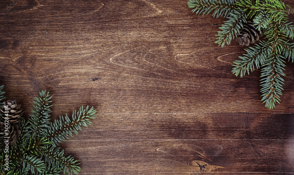 New Year's background. Spruce branches on a wooden table. Ornaments for the New Year tree. Christmas concept. - obrazy, fototapety, plakaty 