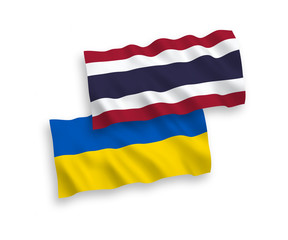 National vector fabric wave flags of Thailand and Ukraine isolated on white background. 1 to 2 proportion.