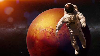 Wall Mural - astronaut during a space walk in orbit of planet mars