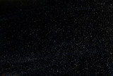 Fototapeta  - abstract real dust floating over black background for overlay