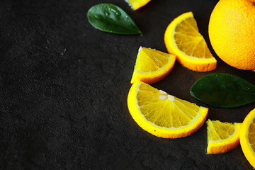 Orange citrus fruit on a stone table. Orange background.