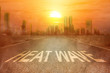 Leinwandbild Motiv Heatwave text on the street on the city with the glowing sun background