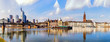 Wide color panorama of the city of Frankfurt am Main,skyscrapers,cathedral,sky clouds, river,bridge,cranes,boats,on s sunny day