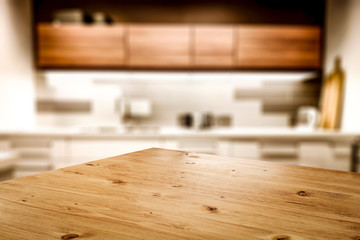 Kitchen table top with empty space for you products or decoration and blurred kitchen furniture background.