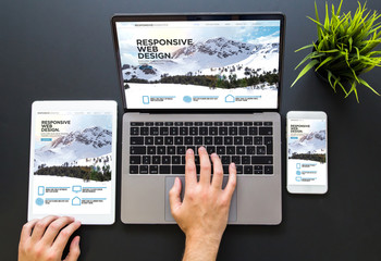 Wall Mural - hands touching responsive web design devices