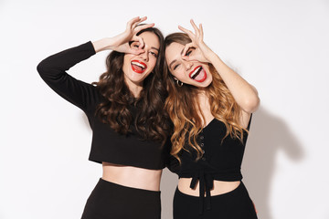 Sticker - Portrait of two funny women smiling and gesturing ok sign