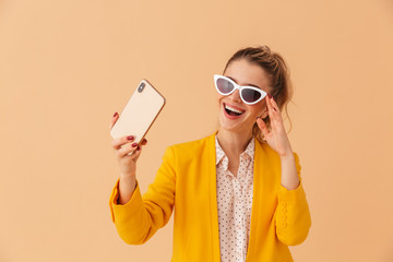 Poster - Photo of cheerful young woman taking selfie photo on cellphone