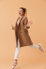 Poster - Photo of delighted attractive woman smiling and jumping