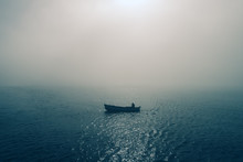 Fishing Boat And Fisherman In The Sea, Foggy Morning Over The Water