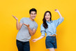 © Atstock Productions - Cheerful excited young Asian man and woman smiling and dancing