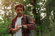 © Bits and Splits - Smartwatch on male hiker hand while hiking in the woods