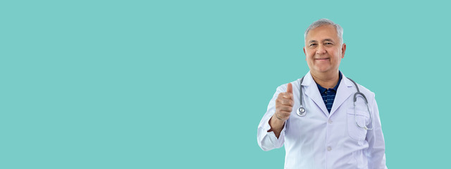 Senior Asian medical doctor isolated on green banner background, thumb-up