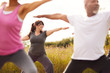 © Monkey Business - Group Of Mature Men And Women In Class At Outdoor Yoga Retreat