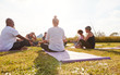 © Monkey Business - Female Teacher Leading Group Of Mature Men And Women In Class At Outdoor Yoga Retreat
