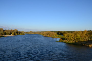 Wall Mural - A beautiful view of the peaceful Narew river. Sunny, autumn day at the river Narew in polish countryside. River in western Belarus and north-eastern Poland, is a right tributary of the Vistula River. 