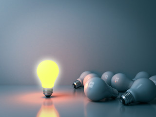 Fototapete - One glowing light bulb standing out from the unlit incandescent bulbs in the dark room background with reflections leadership and different business creative idea concepts 3D rendering
