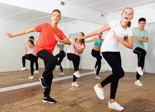 Teenage Dancers Practicing Active Vigorous Dance In Modern Studio