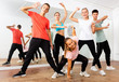 © JackF - Cheerful teenage boys and girls having fun in choreography class, posing with female trainer
