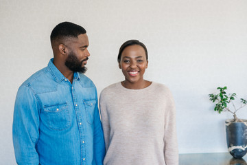 Poster - Smiling African American couple standing at home together