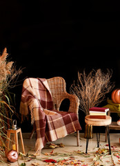 Wall Mural - Beautiful autumn composition with wicker armchair near dark wall