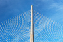 Rope And Pylon Of Modern Suspension Bridge Against Blue Sky. Building Abstract Background
