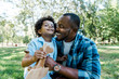 © LIGHTFIELD STUDIOS - happy african american father looking at cute son holding wooden toy biplane