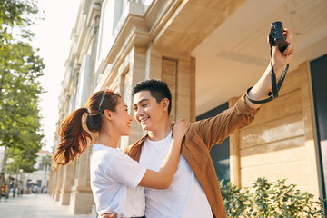 Happy tourists taking photo of themselves