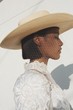 © Christopher Michael - Close up of model wearing straw hat with veil and formal dress