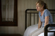 © PhotoAlto - Thoughtful sad mature woman sitting in bedroom