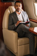© LIGHTFIELD STUDIOS - selective focus of bearded businessman holding notebook and pen in plane