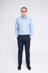 full length portrait of handsome businessman over gray background