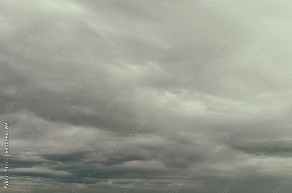Soft background with stratus clouds. Dramatic cloudscape under cinematic color filter. - obrazy, fototapety, plakaty 