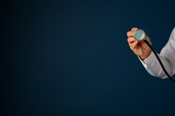 Hand of a doctor holding stethoscope disk towards the camera