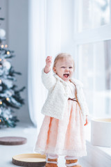 Wall Mural - little girl rejoices in christmas