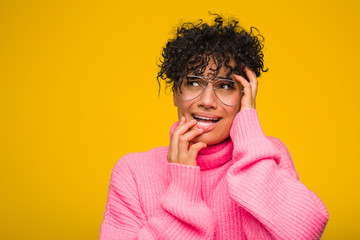 Wall Mural - Young african american woman wearing a pink sweater whining and crying disconsolately.