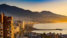 Sunset In Fuengirola, Spain. Golden Hour At The Coastline With Skyscrapers And Hills