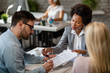 © Drazen - African American bank manager and a couple signing a contract in the office.