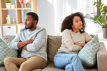 relationship difficulties, conflict and people concept - unhappy african american couple having argument at home