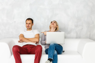 Wall Mural - Portrait of happy young couple using laptop isolated on gray background