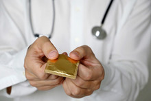 Doctor Giving Condom, Contraception, Safe Sex Concept. Man Holding Contraceptive In Hands, Health Care And Prevention Of Sexually Transmitted Diseases