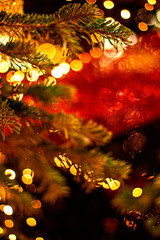 Wall Mural - decorated christmas tree on blurred background with abstract golden bokeh lights. beautiful merry ch