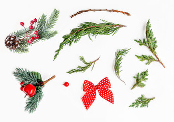 Christmas creative layout with various fir tree branches, decorations and ornaments isolated on white background. Flat lay