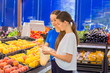 © Natalia - Teen girls shopping in supermarket reading product information. Choosing daily product.Concept of healthy food, bio, vegetarian, diet.